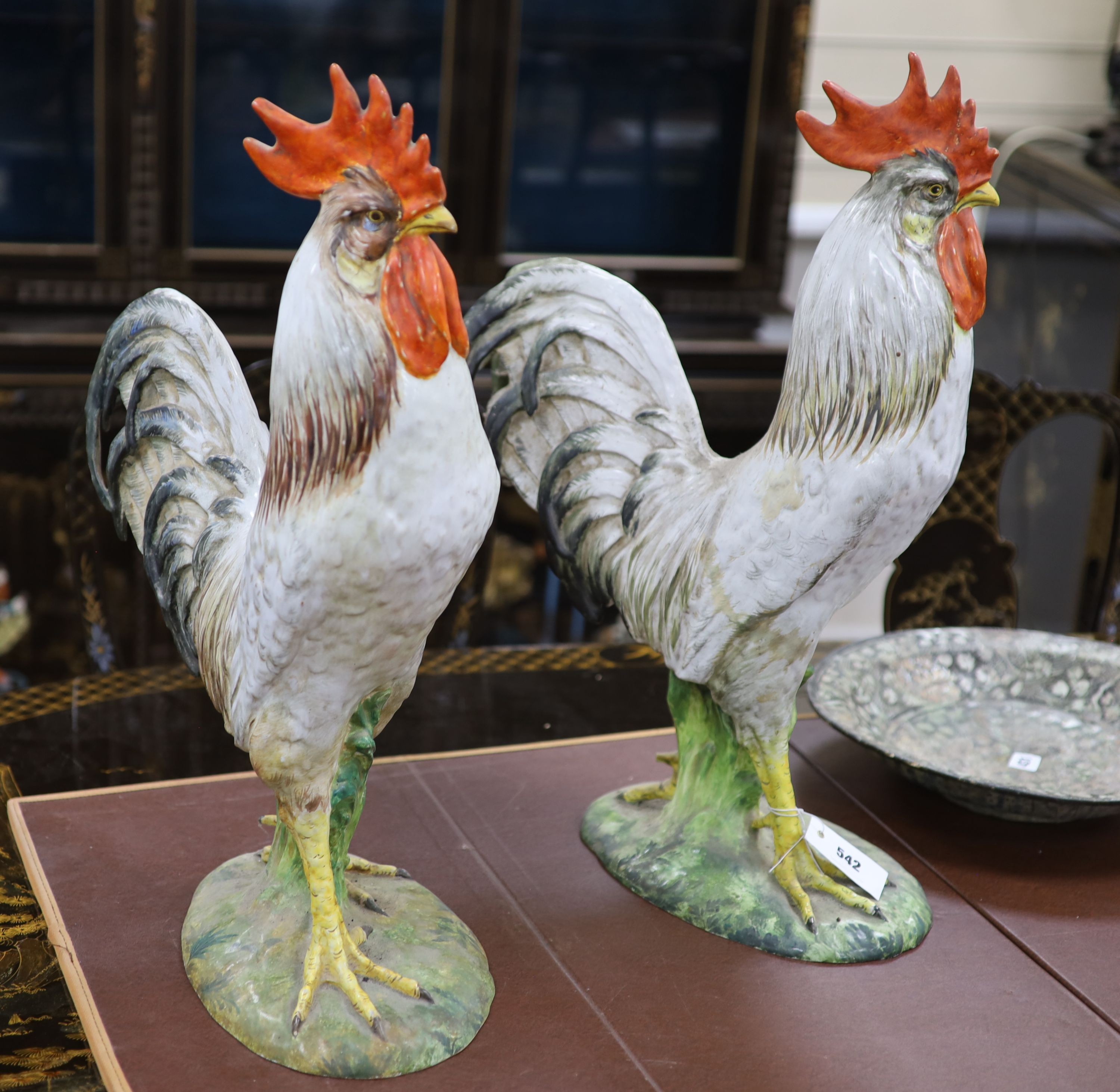 A matching pair of large Italian Maiolica models of cockerels, 60.5cm high